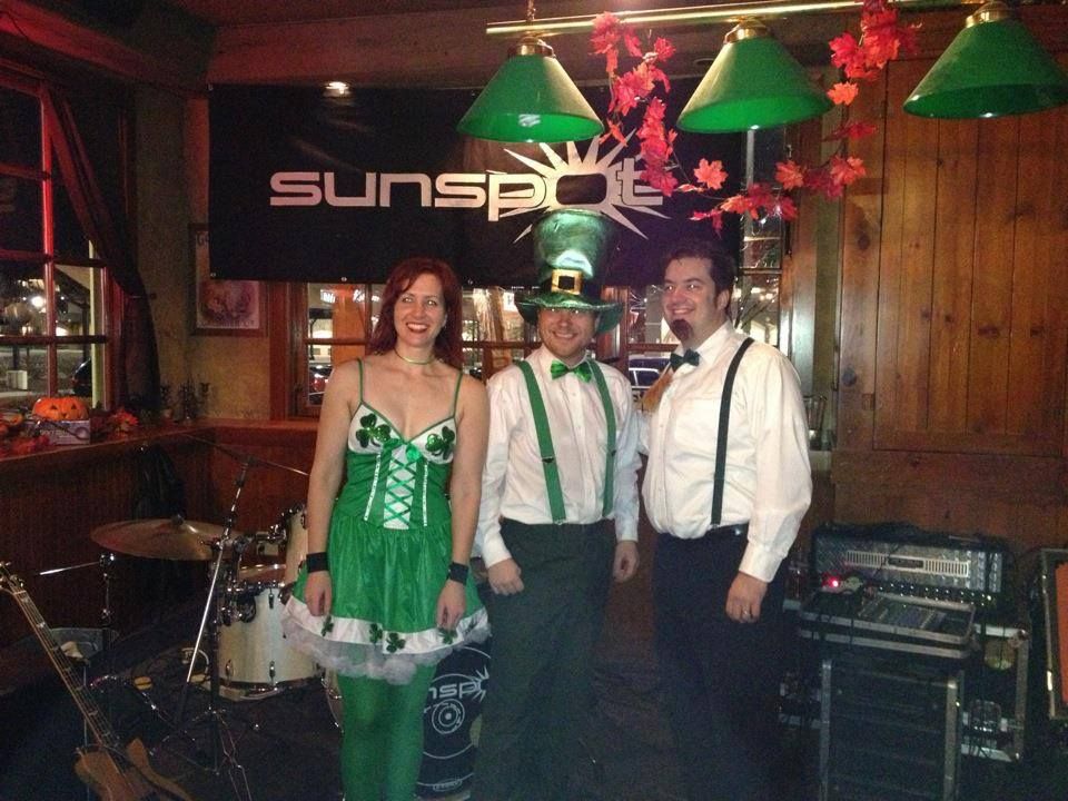 A group of people standing in front of a sign that says sunspot