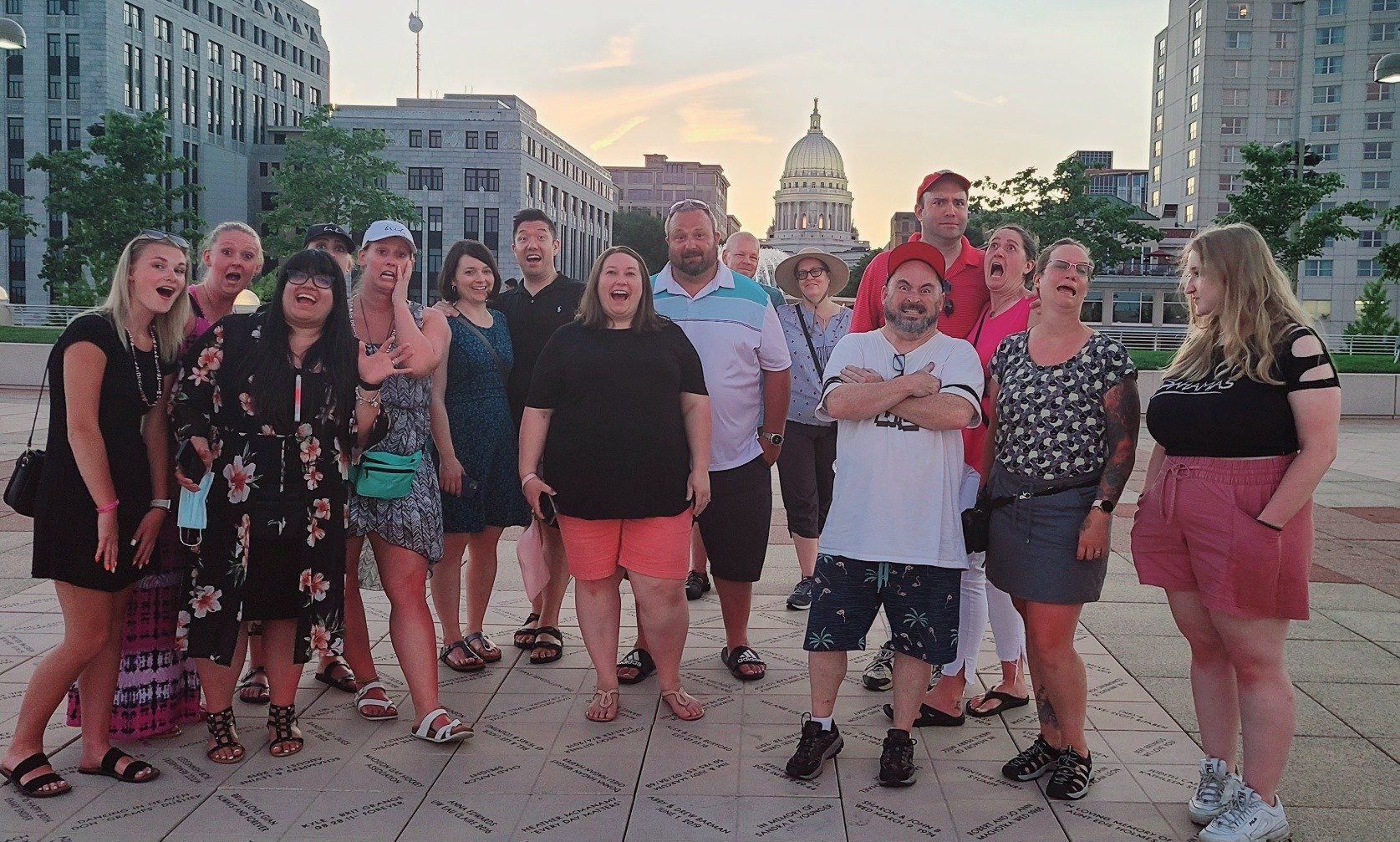 A group of people are posing for a picture in front of a building.
