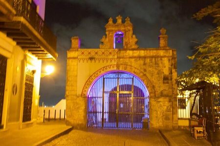 A building with a blue light shining on it at night.