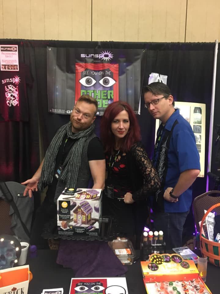 A group of people are posing for a picture at a convention.