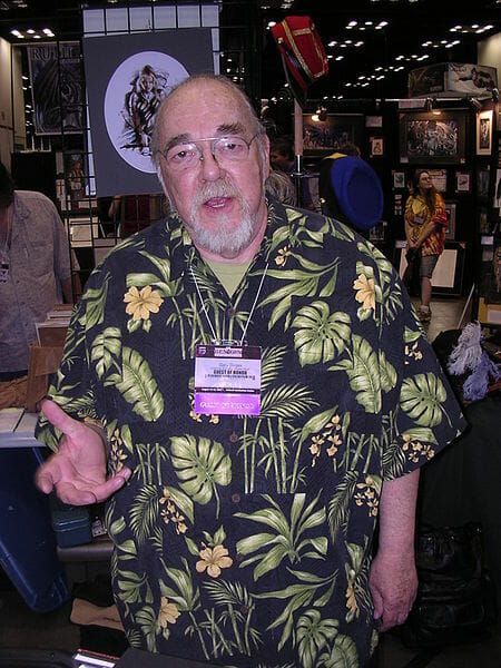 A man wearing a hawaiian shirt has a name tag that says ' j.p. ' on it