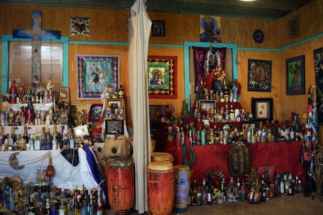 A room filled with lots of religious items and drums.