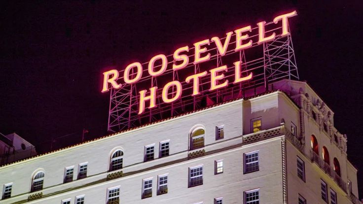 The roosevelt hotel is lit up at night.