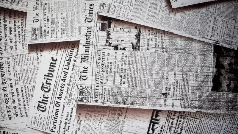 A bunch of old newspapers are stacked on top of each other.