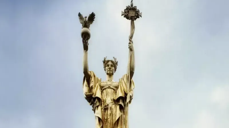 A statue of a woman holding a bird and a laurel wreath