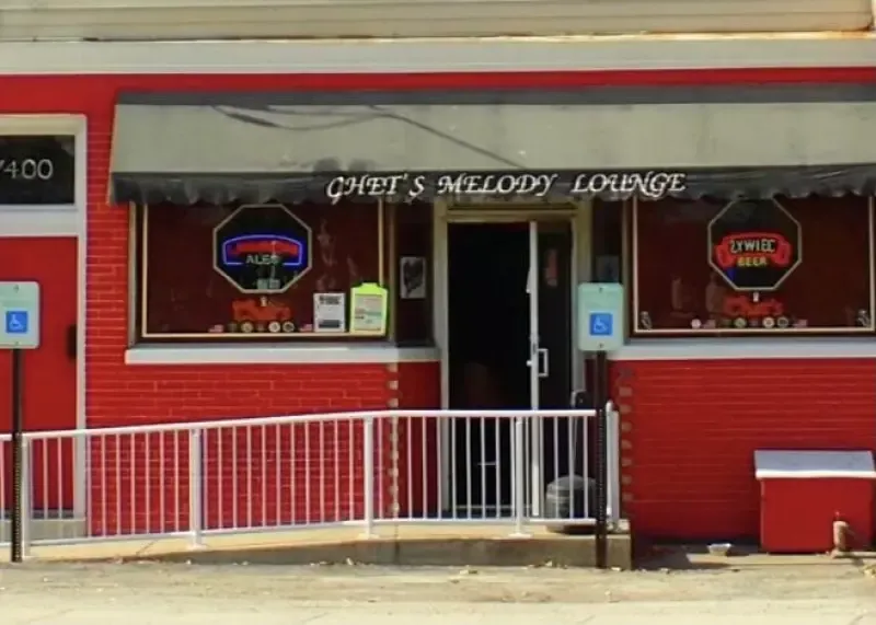 A red building with a sign that says chef 's melody lounge