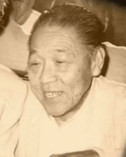 A black and white photo of an elderly woman smiling.