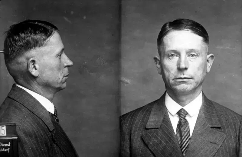 A black and white photo of a man in a suit and tie.