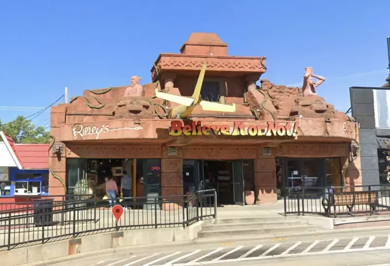 A building with a plane on top of it that says believe in yourself