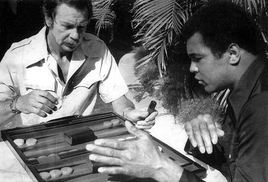 World champion Backgammon player Baron Vernon Ball playing with world champion boxer Muhammad Ali