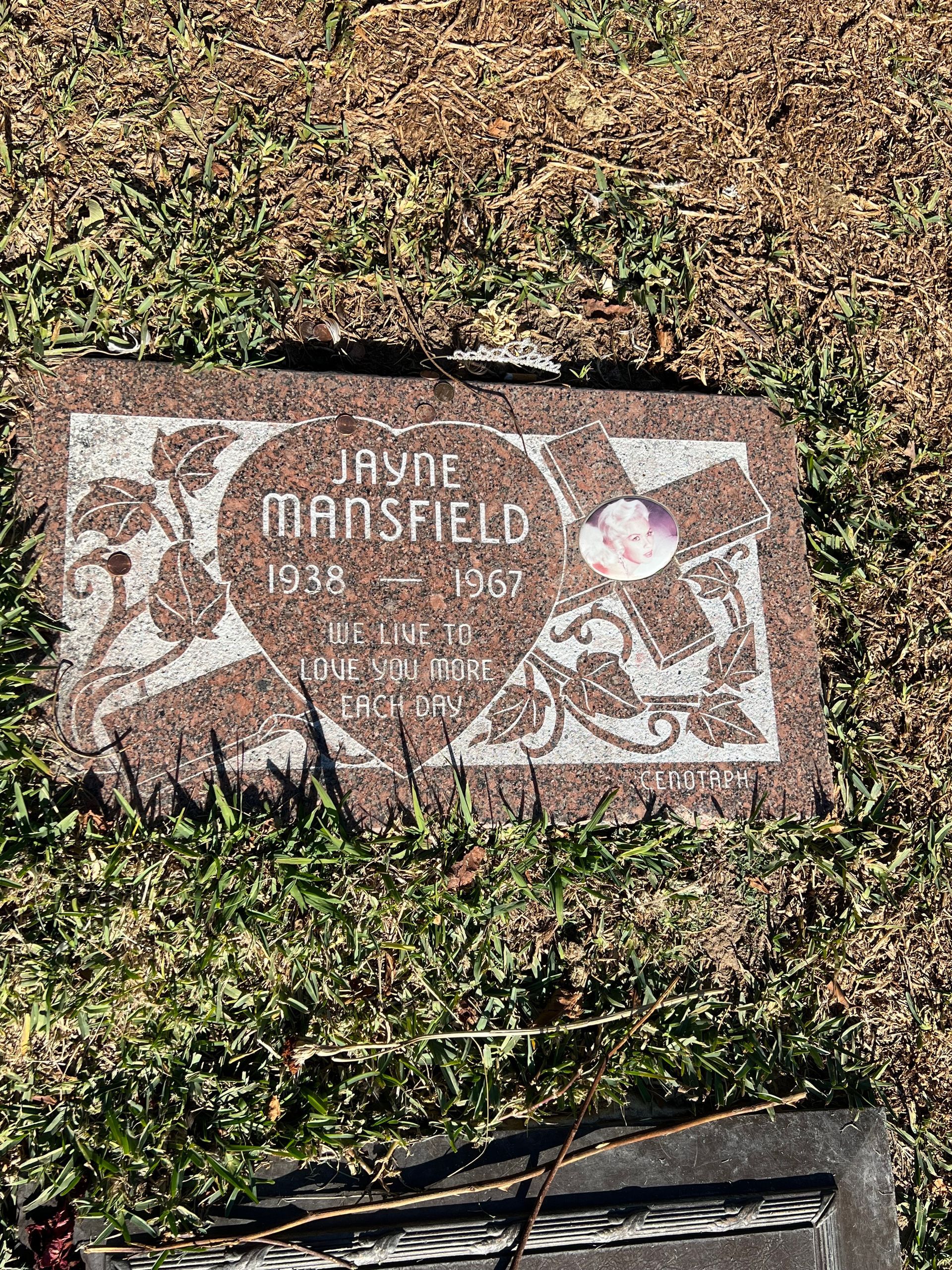 A gravestone in a cemetery with a picture of a woman on it.