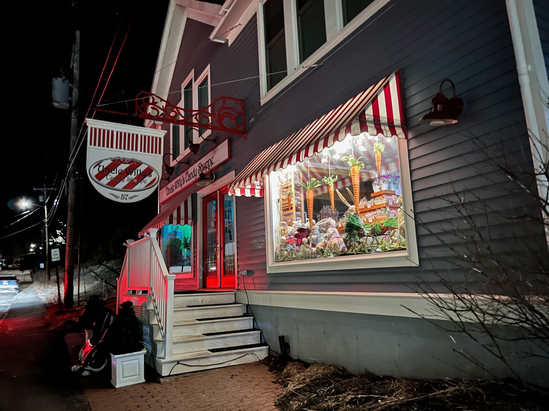 A store front with a red and white awning and stairs