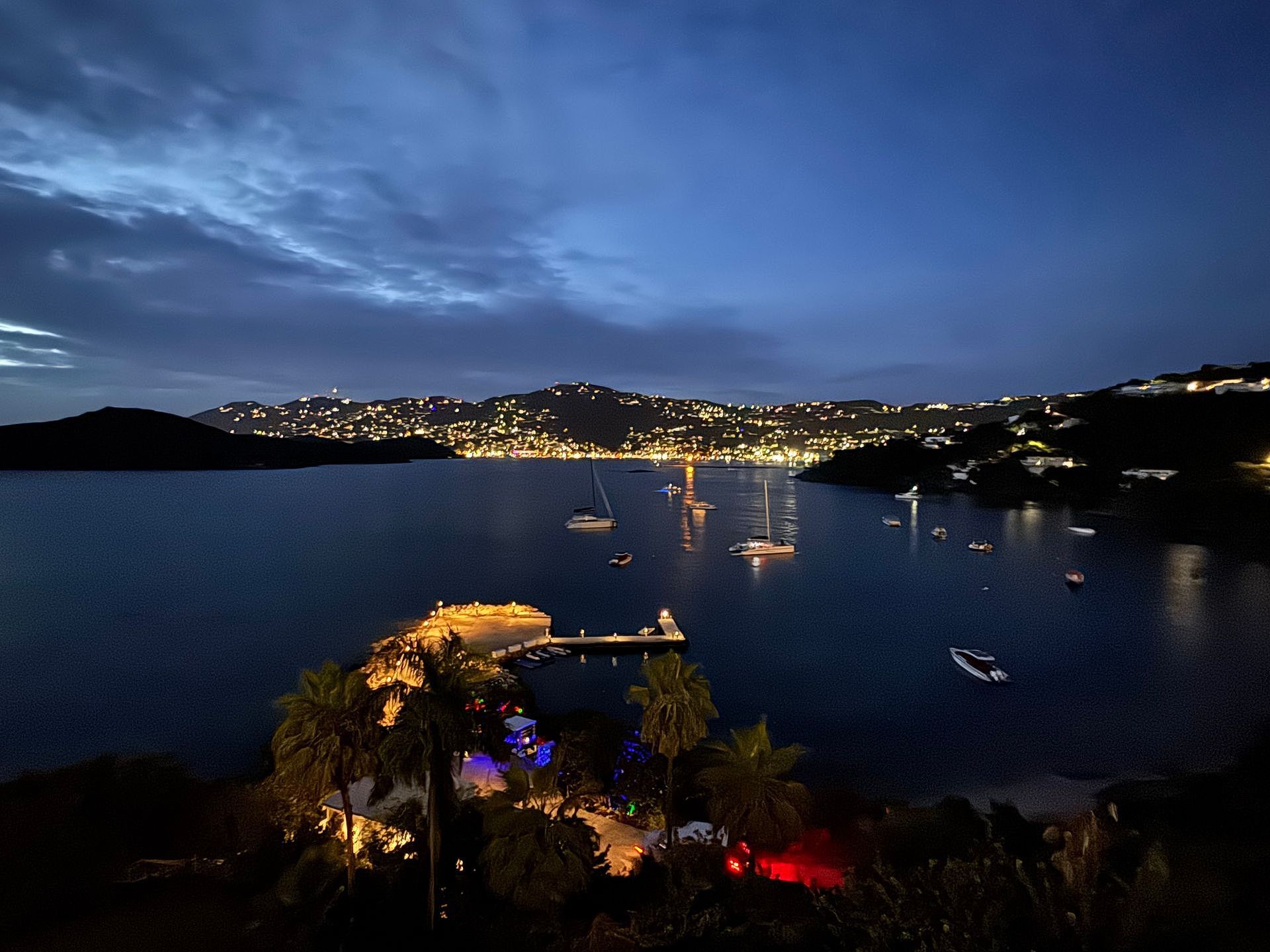 A large body of water with boats in it at night