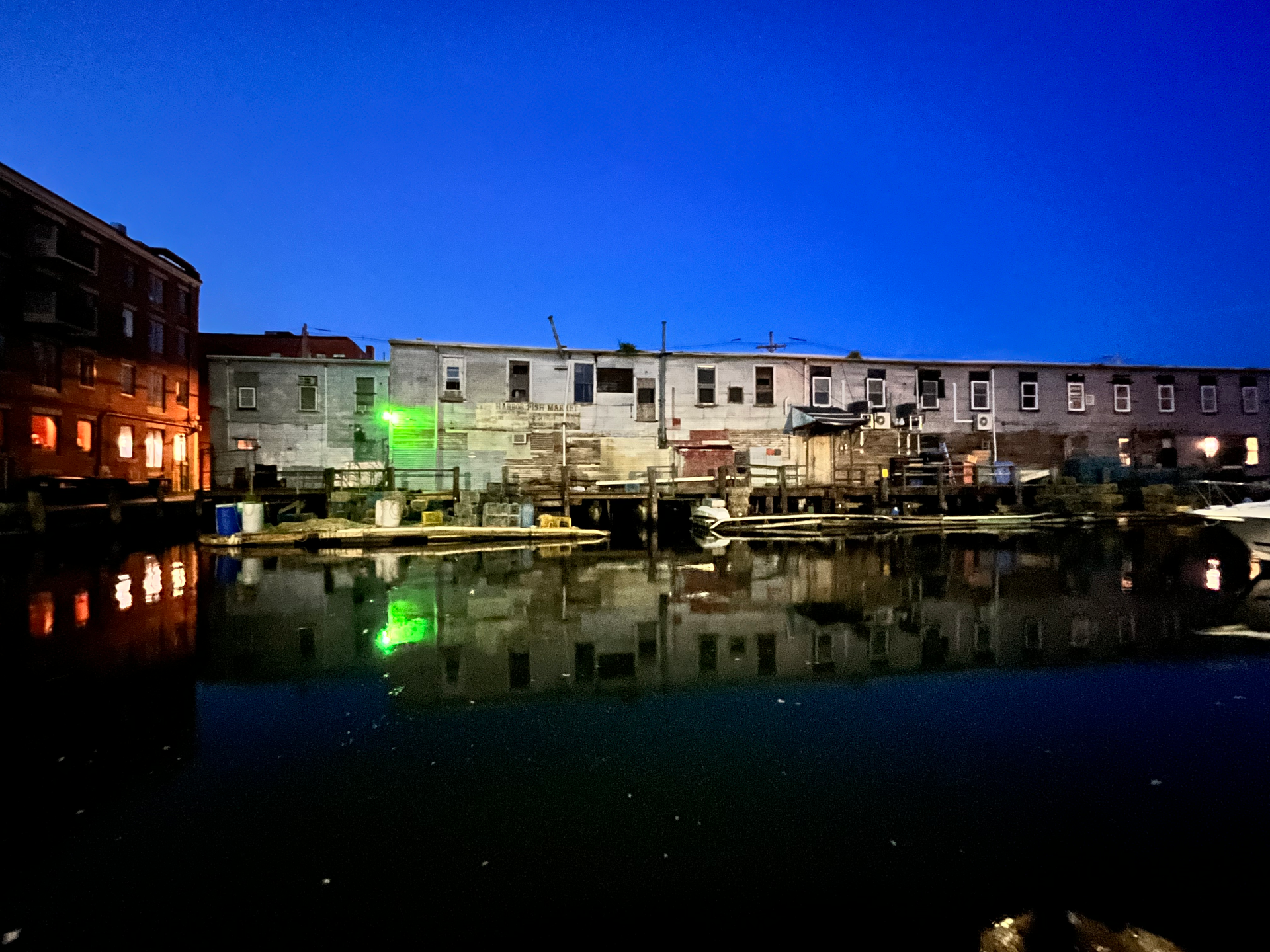 A row of buildings next to a body of water at night