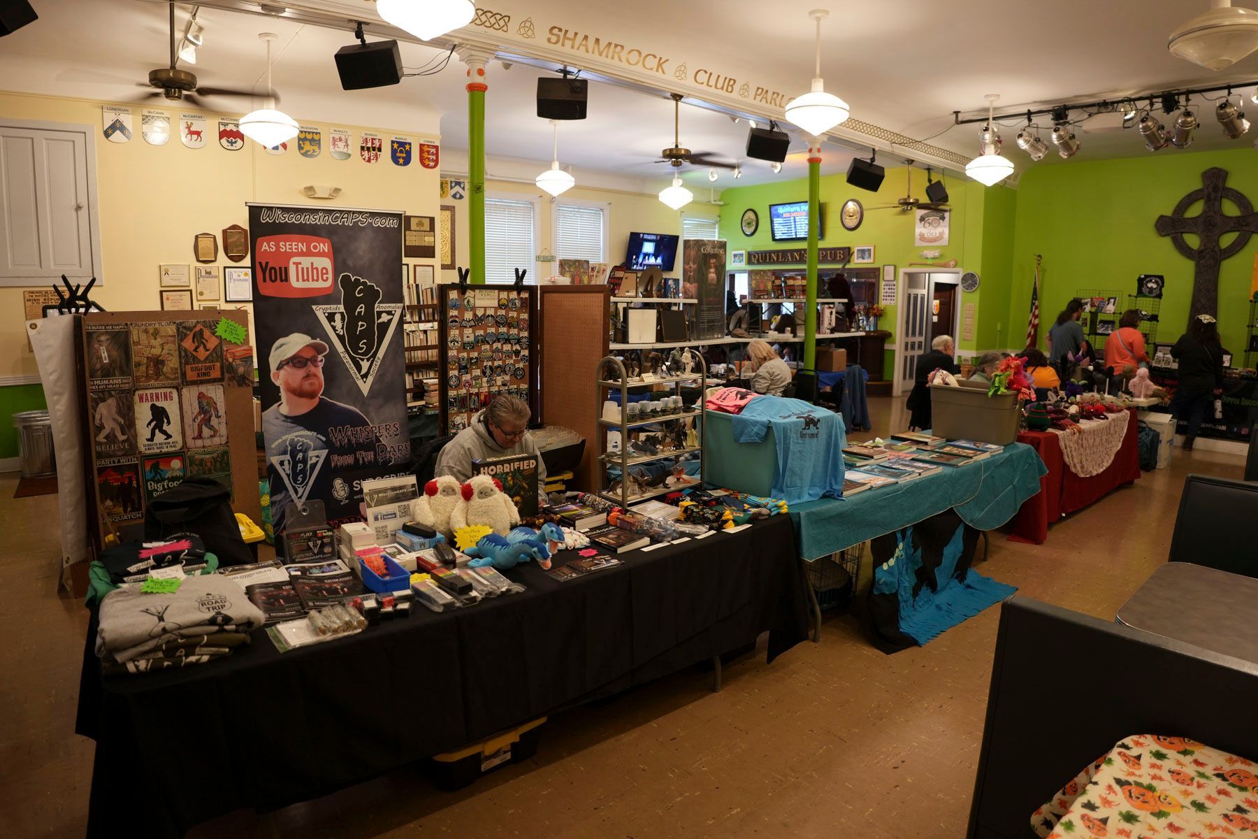 A large room with lots of tables and a sign that says ' airsoft ' on it