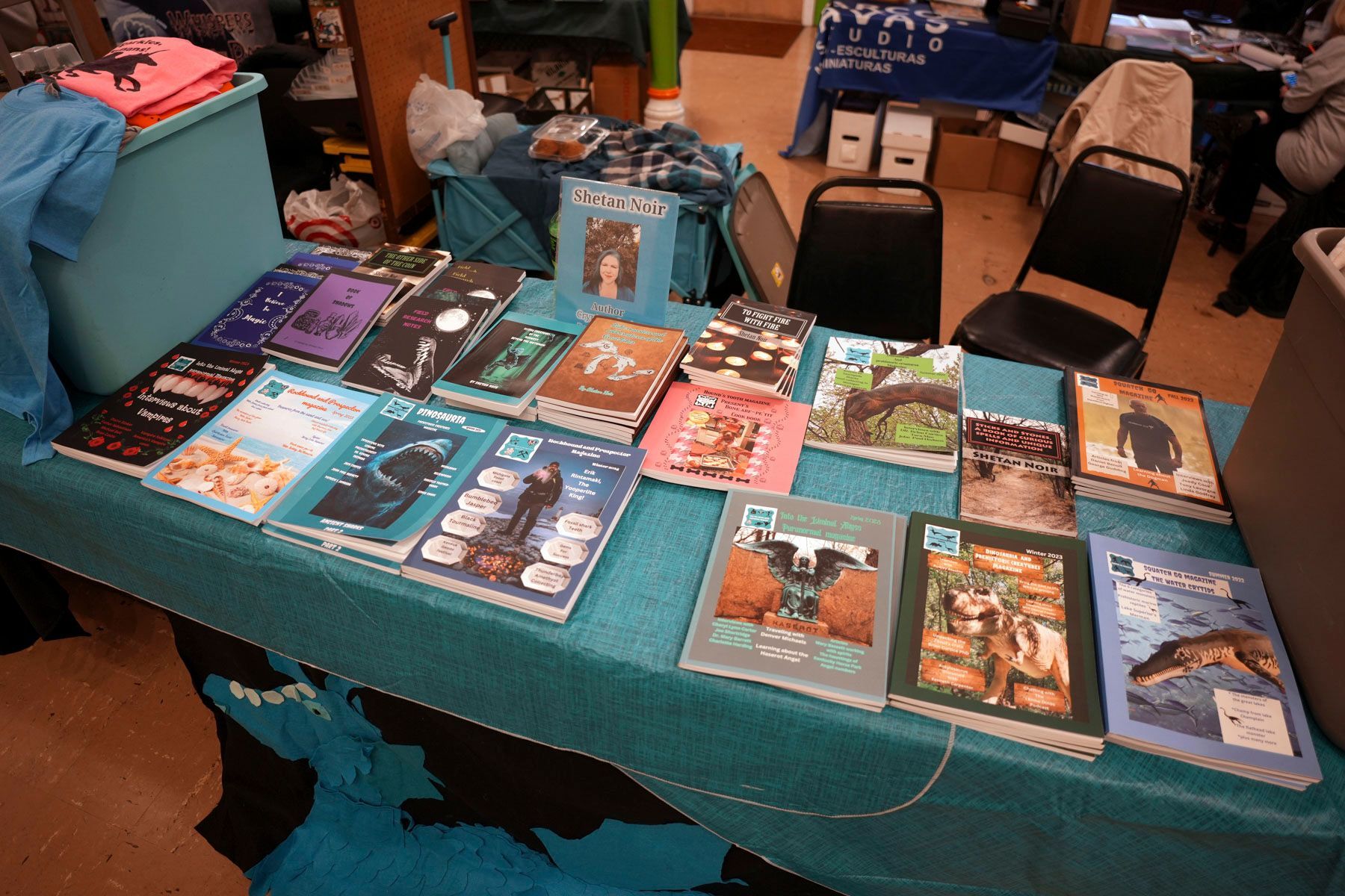 A table with a lot of books on it including one that says ' birds ' on it