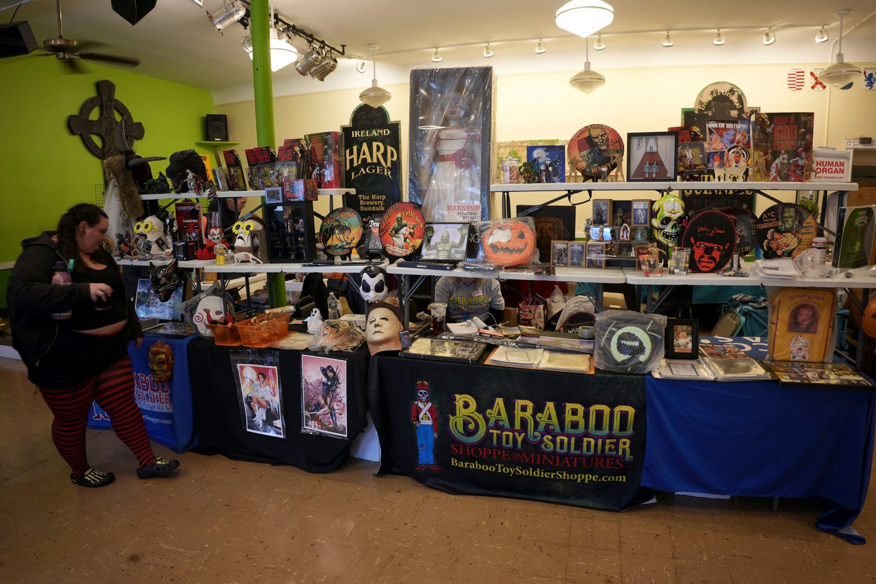 A woman stands in front of a table with a banner that says baraboo