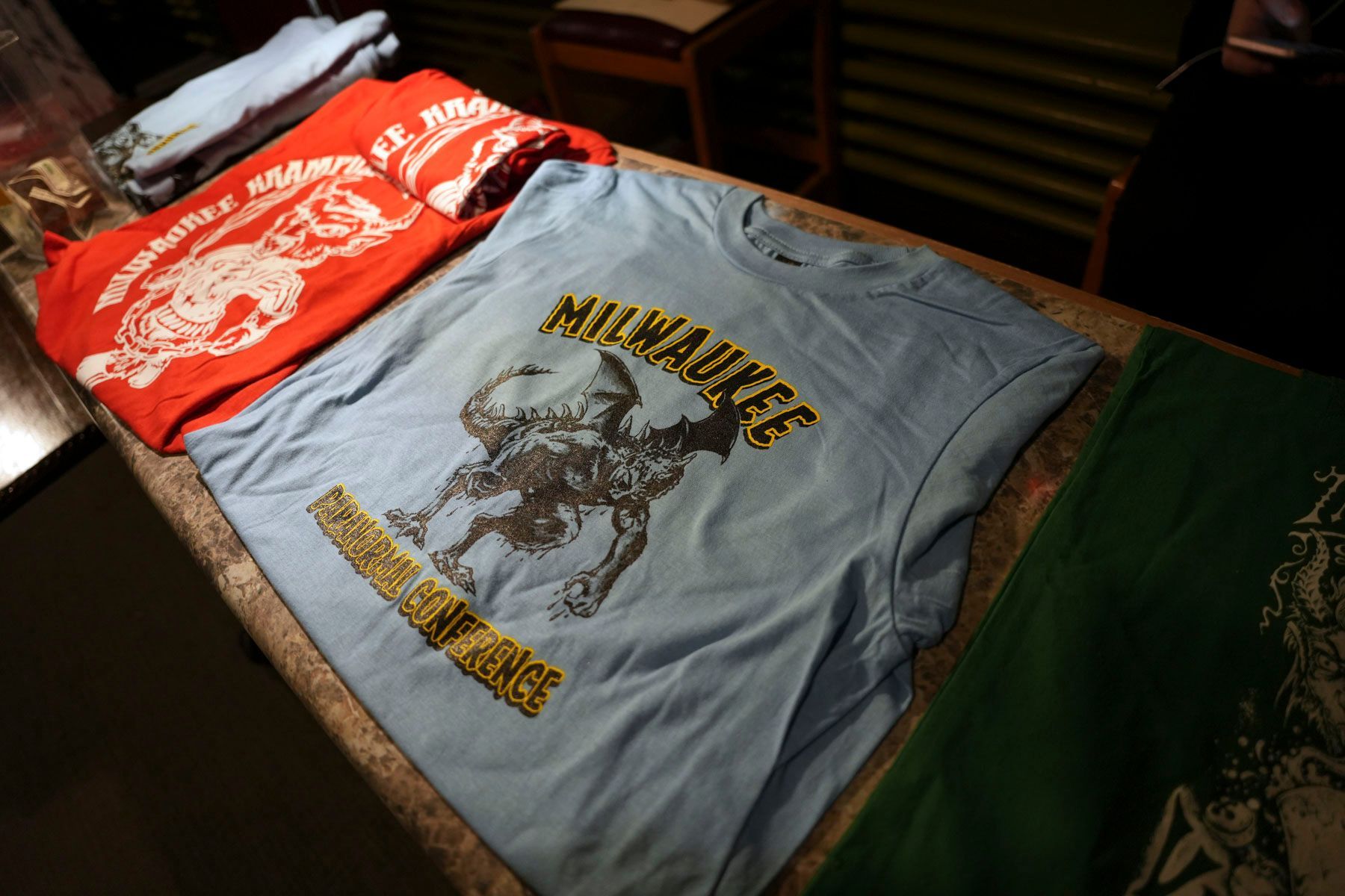 A blue milwaukee t-shirt sits on a table