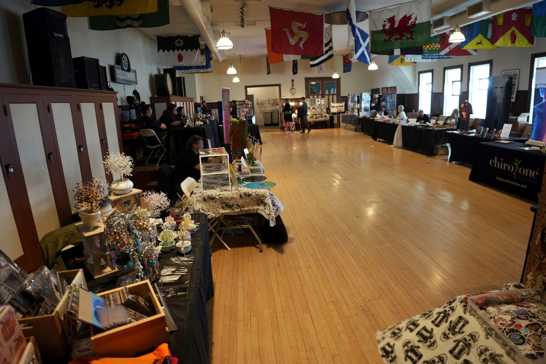 A large room with many tables and flags hanging from the ceiling