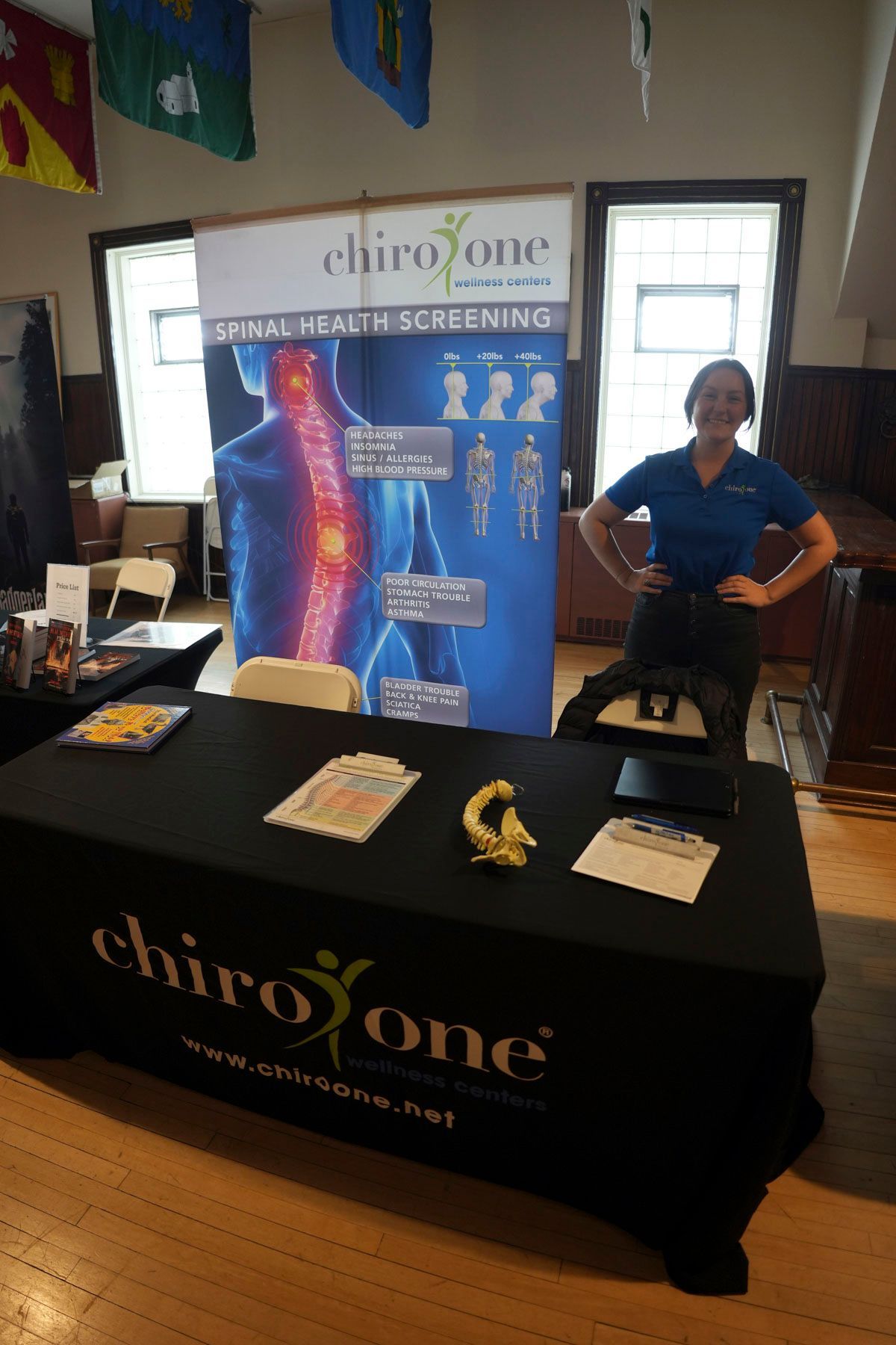 A woman stands in front of a chirozone table