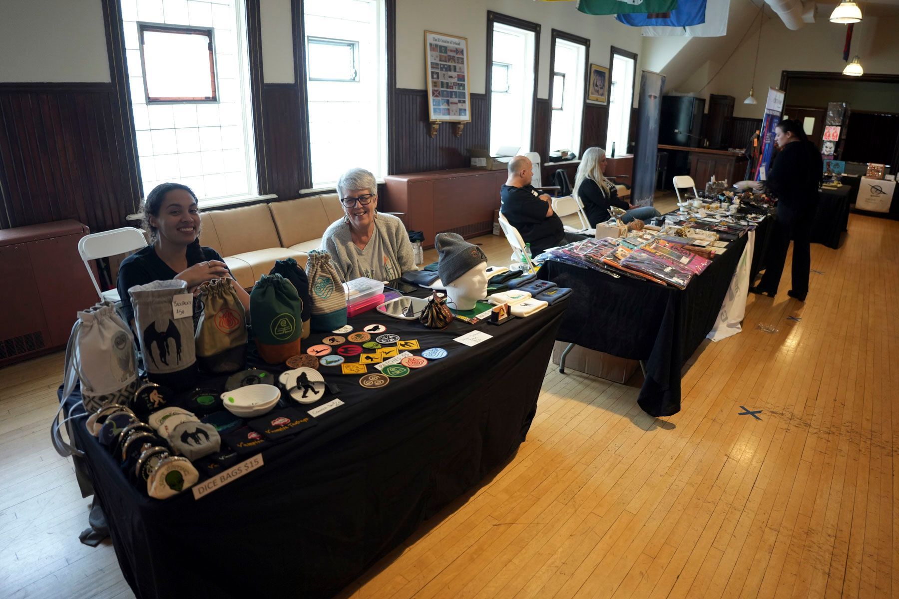 A woman sits at a table with a black table cloth