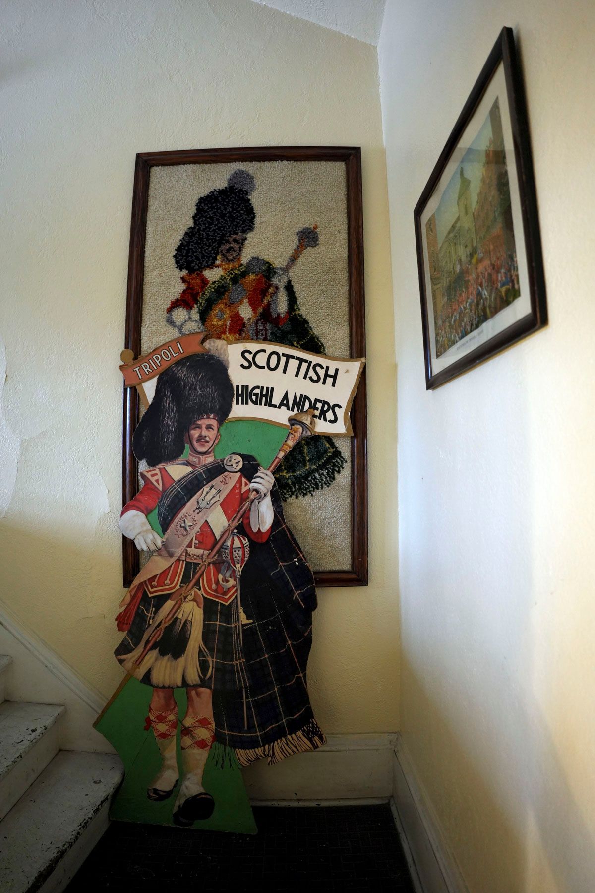 A cardboard cutout of a man holding a sign that says scottish highland set