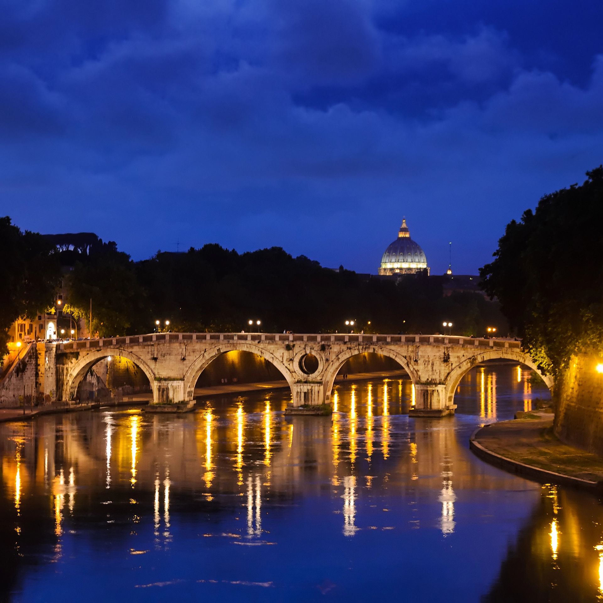 The Ponte Sisto Bridge at night with St. Peter's Basilica in the background