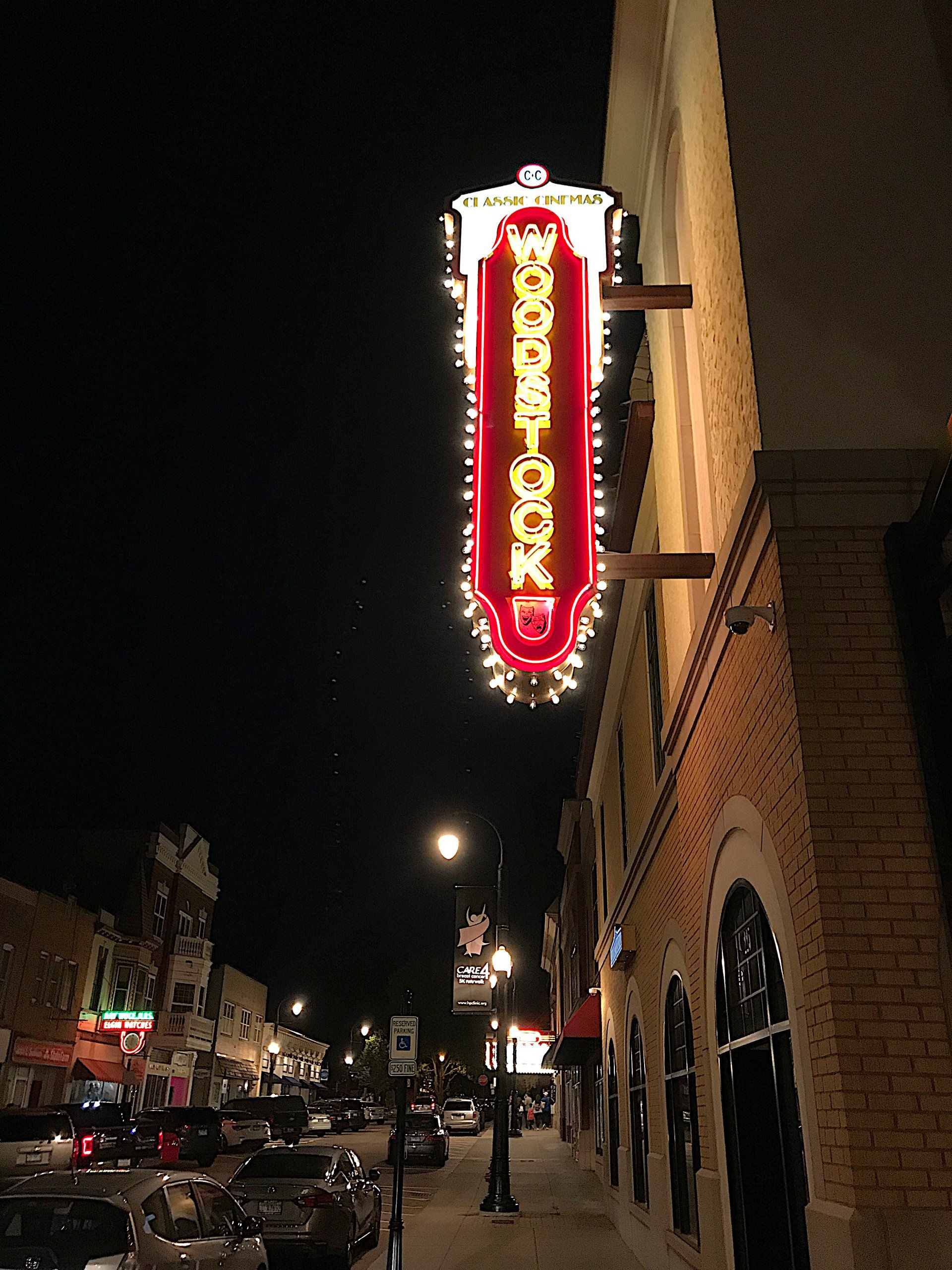 A neon sign that says ' Woodstock' on it