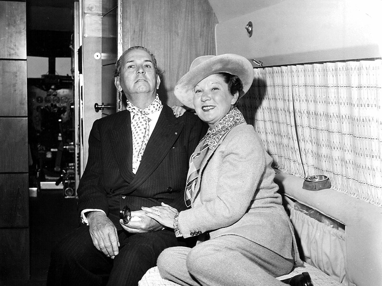 A black and white photo of a man and woman sitting next to each other