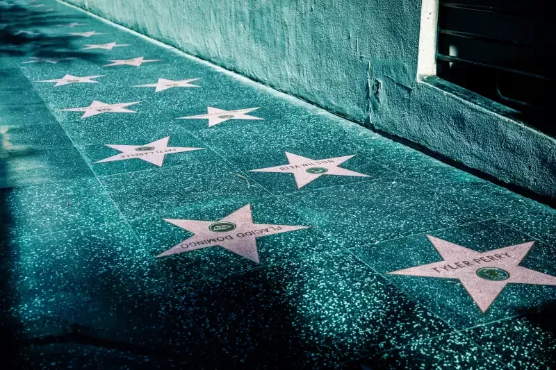 A row of hollywood walk of fame stars on a sidewalk