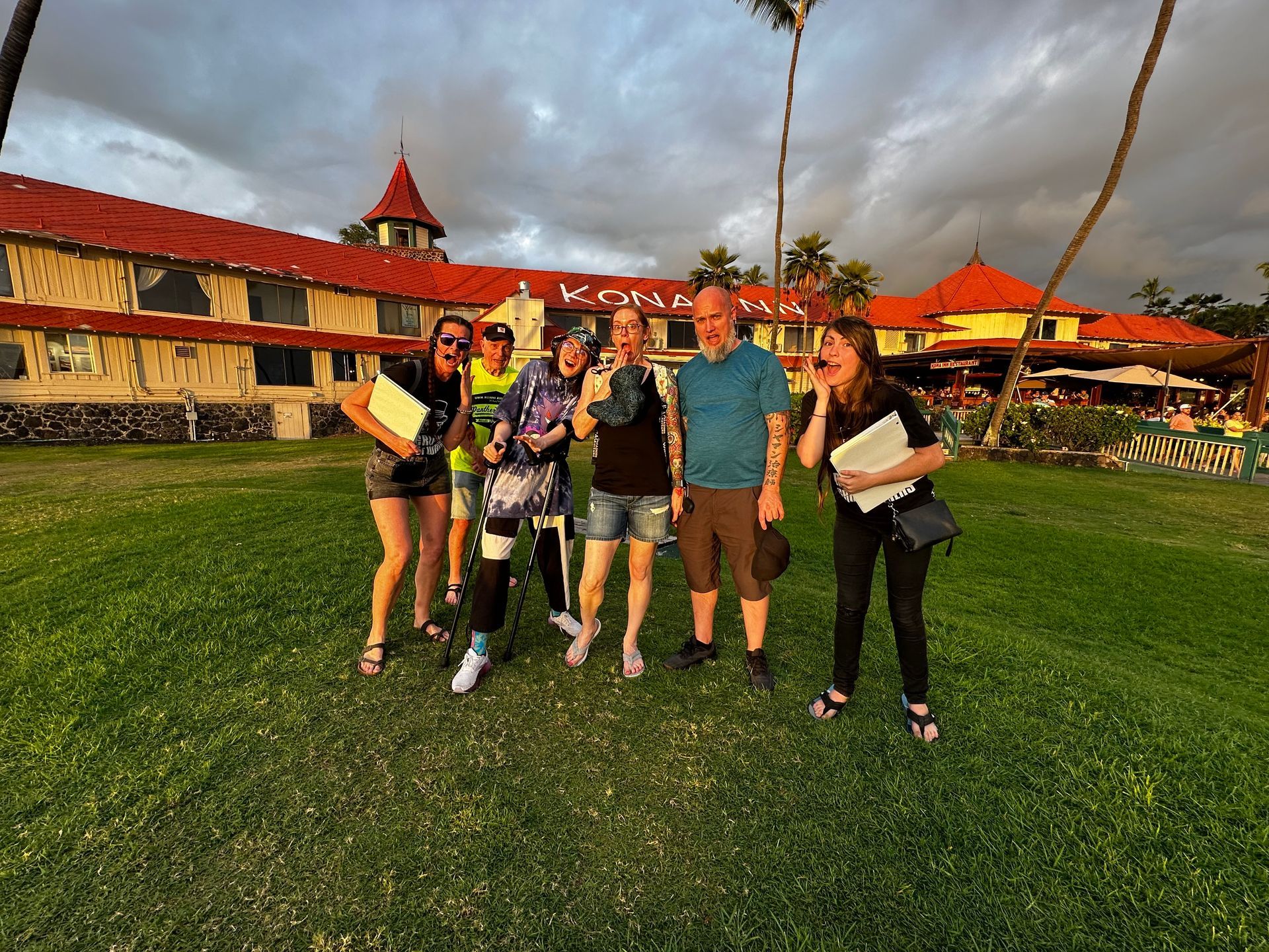 A group of people posing for a picture in front of a hotel