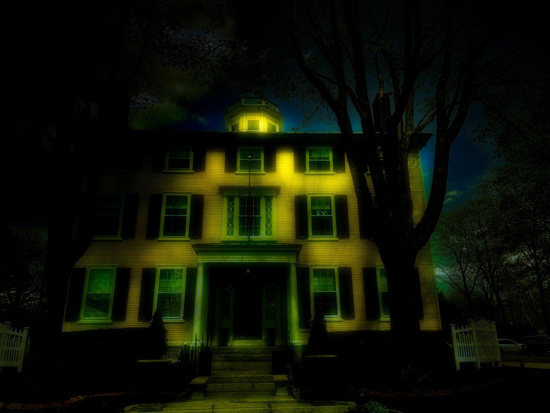 An old house glows in the darkness