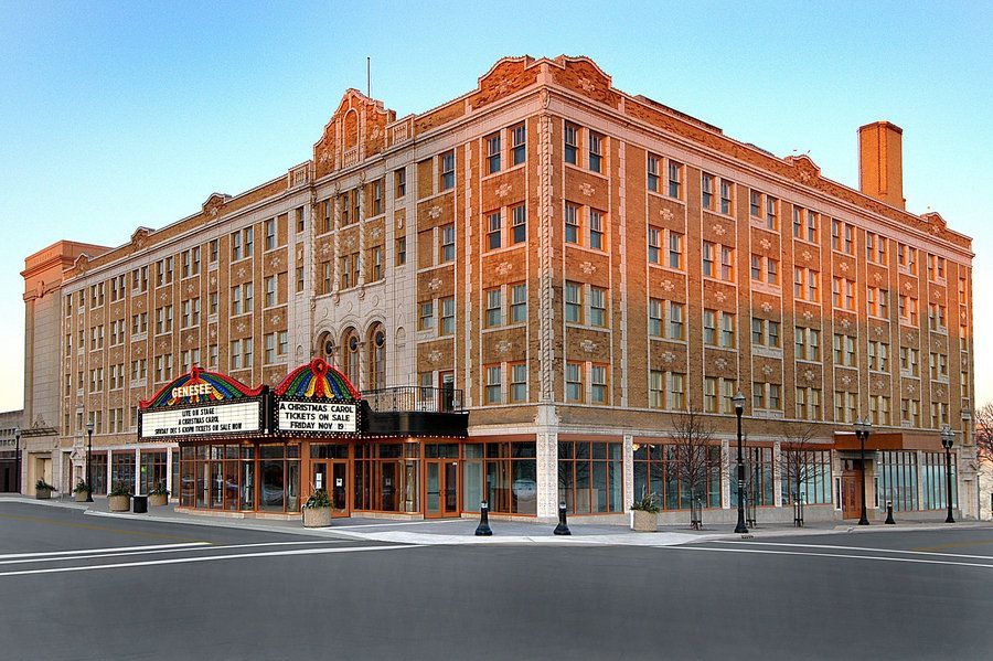 A large brick building with a theater in front of it