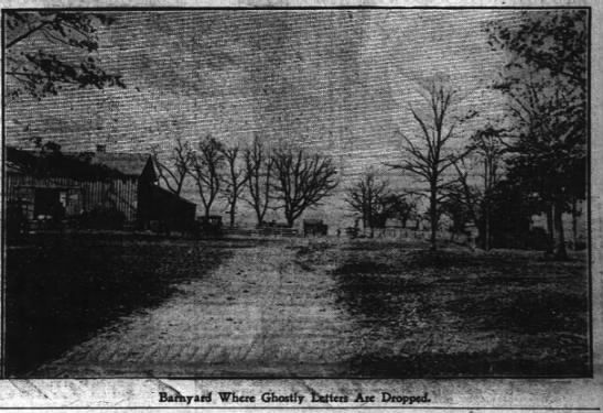 A black and white photo of a field with trees and a house in the background