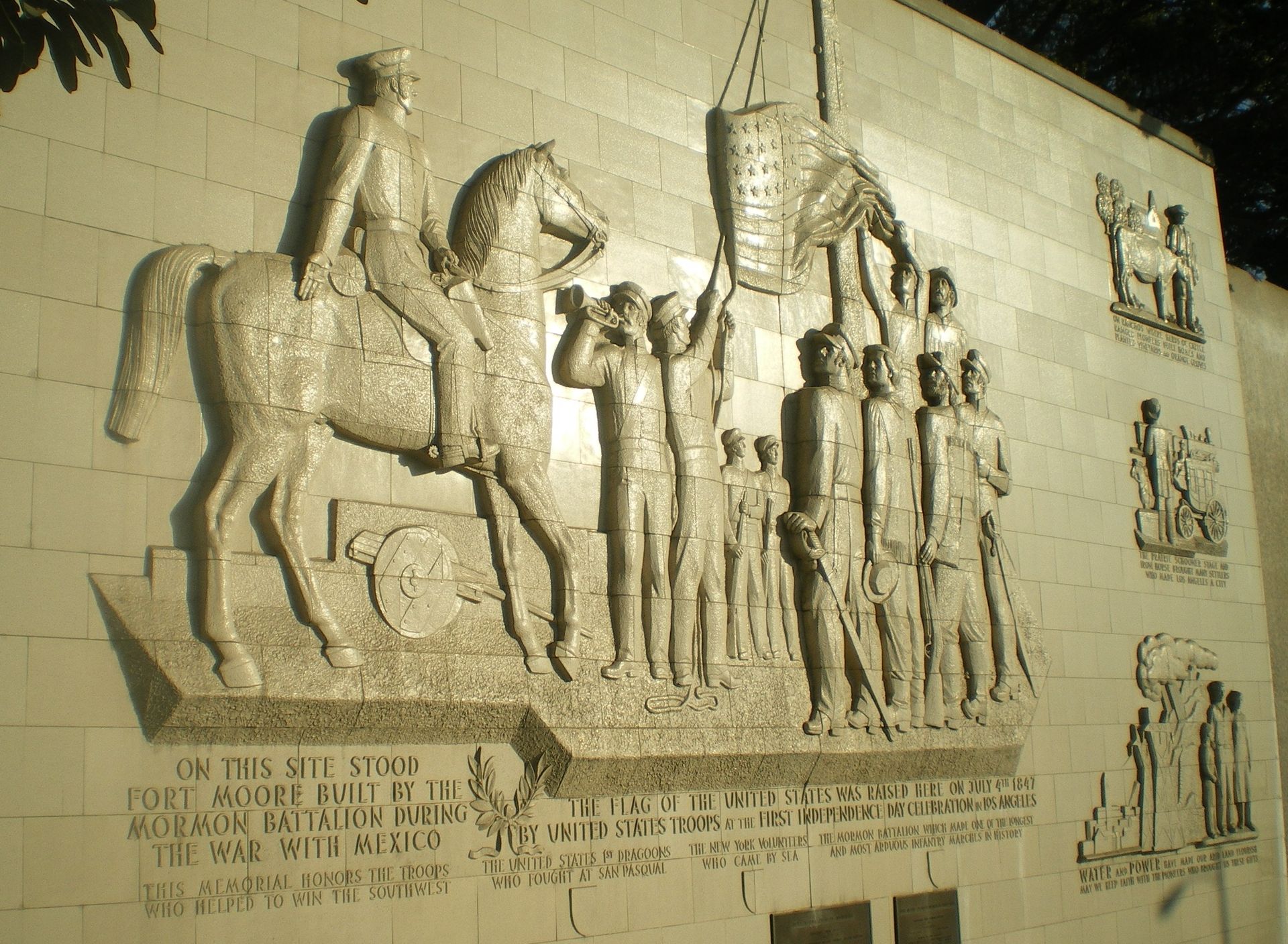 A statue of a man riding a horse on a wall