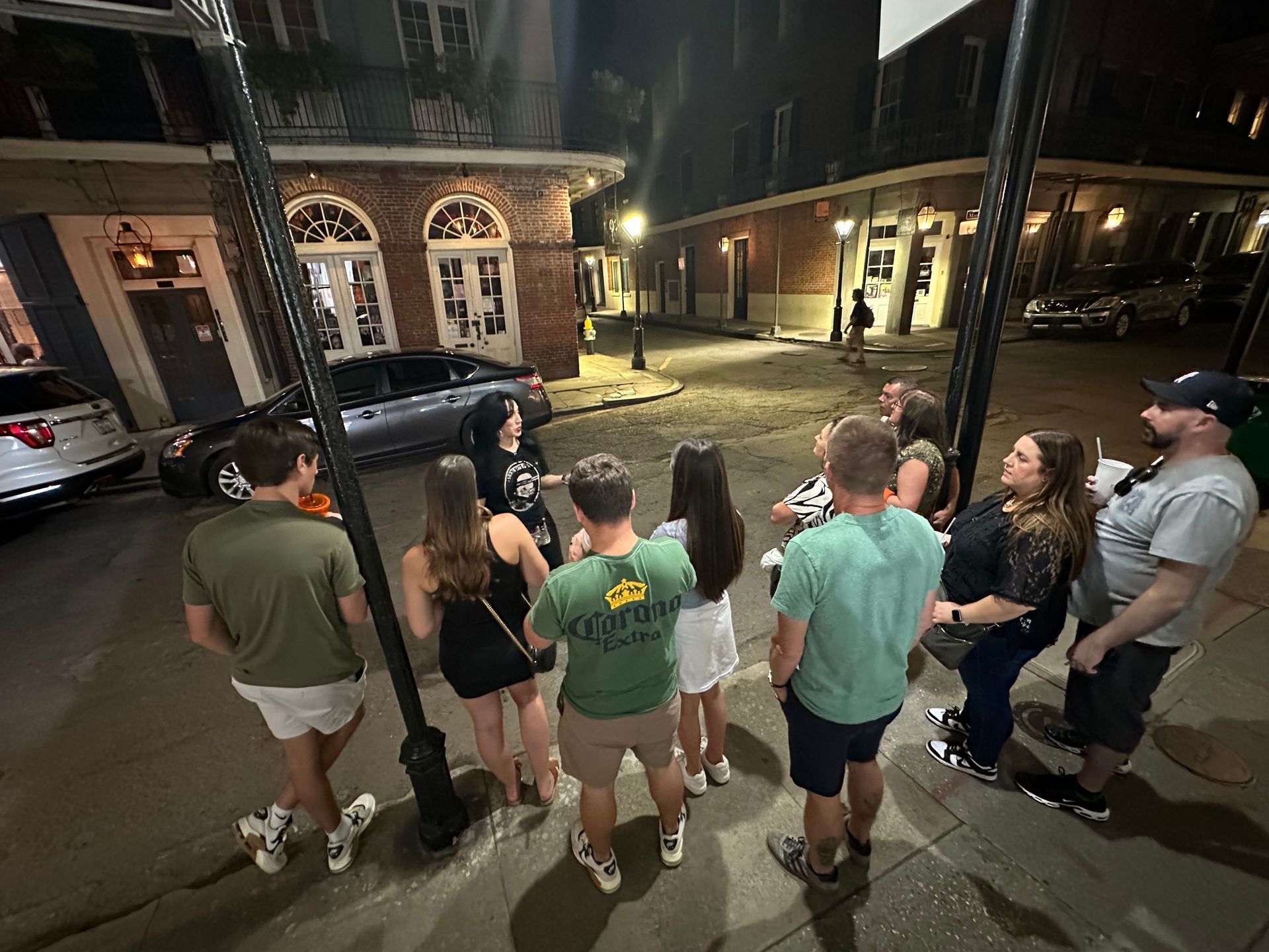 people standing in french quarter listening to a woman