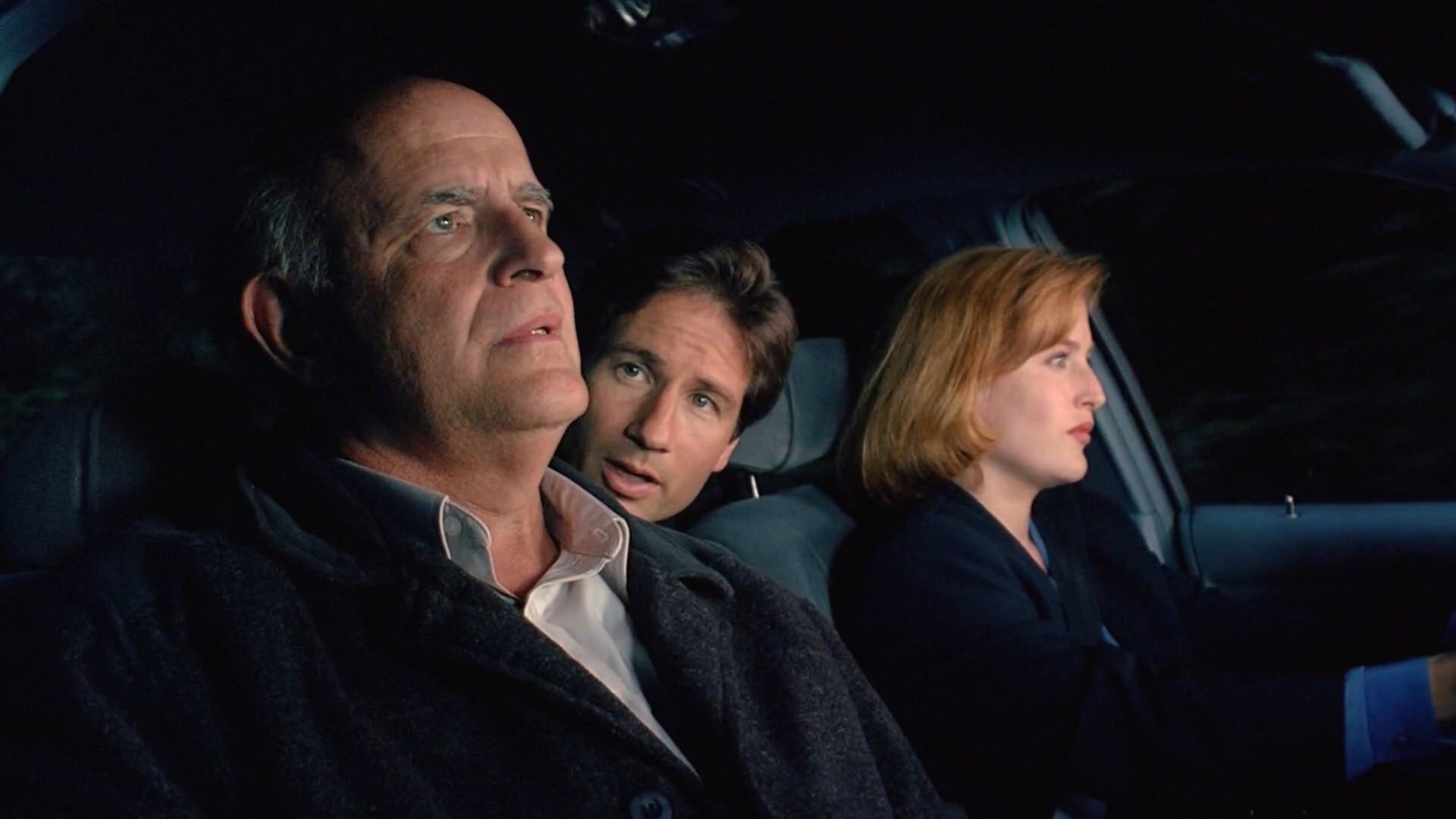 Peter Boyle as Clyde Bruckman, David Duchovny as Agent Fox Mulder, Gillian Anderson as Agent Dana Scully in The X-Files