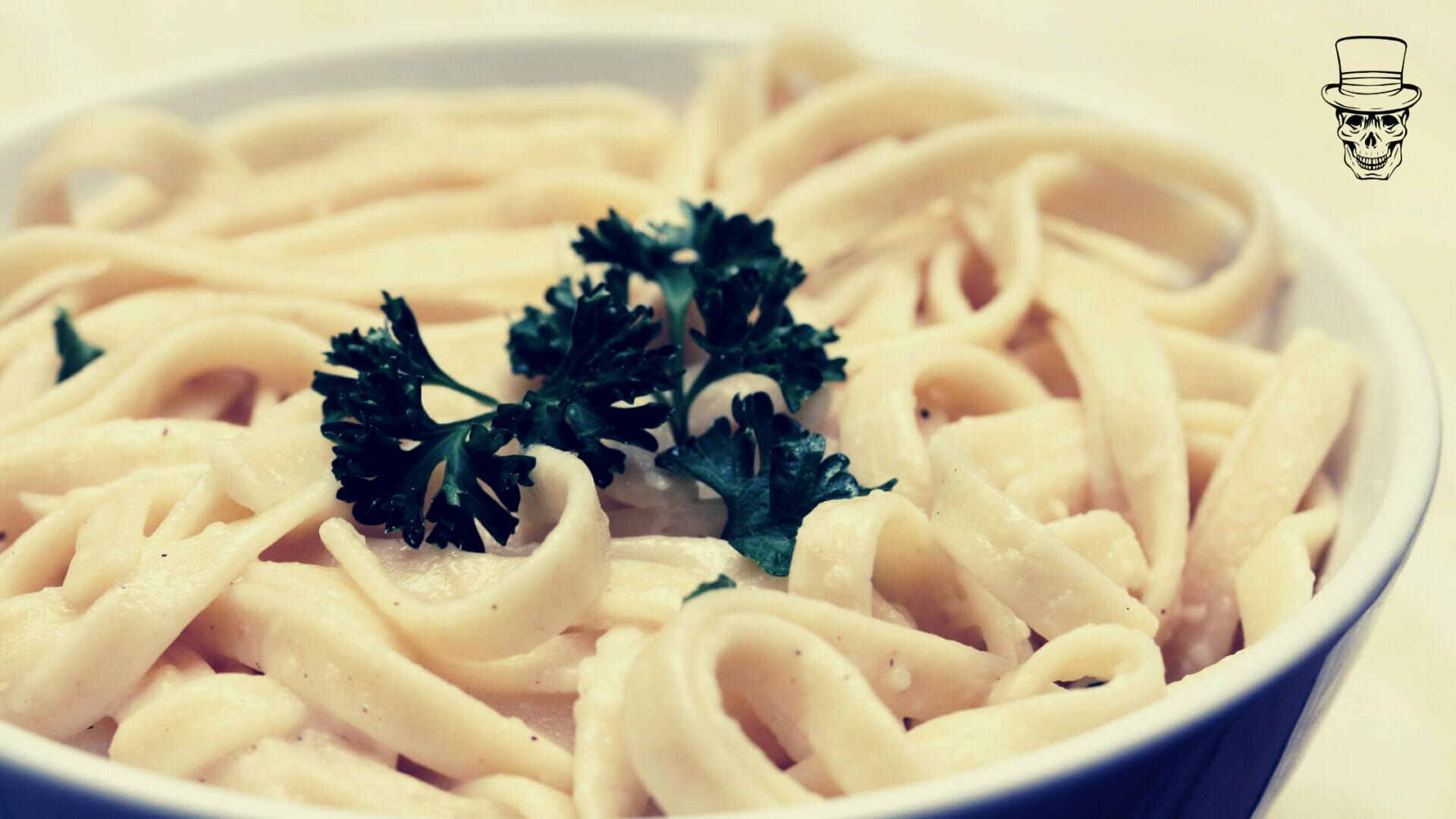 A bowl of noodles with parsley on top