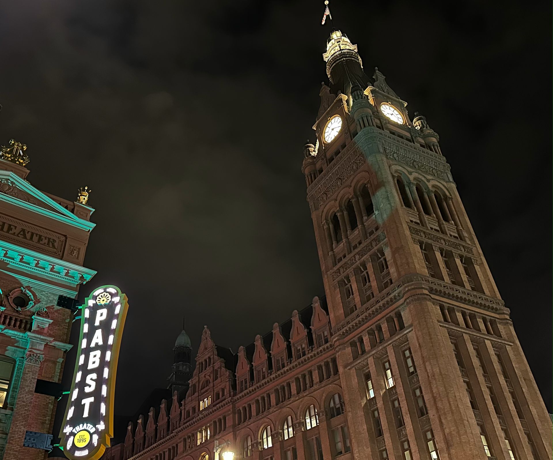 A large building with a clock tower and a sign that says ' pabst ' on it