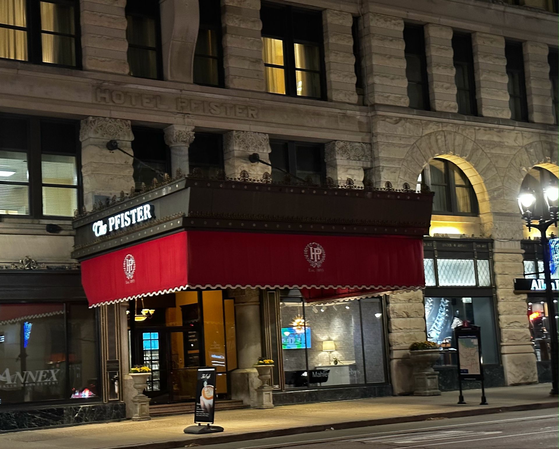 A building with a red awning that says ppster on it