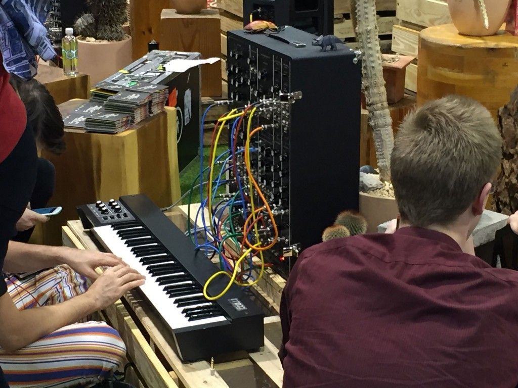 A group of people are playing a keyboard in a room.