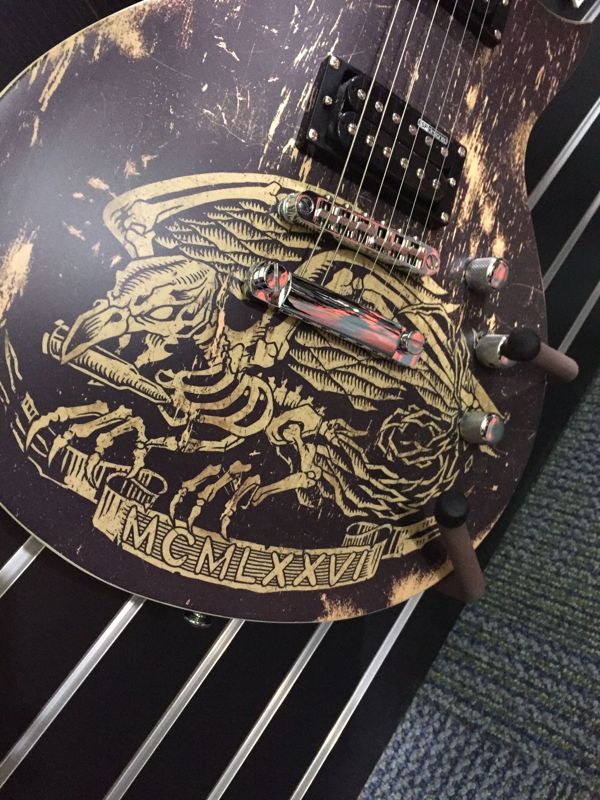 A guitar with a picture of a skeleton on it