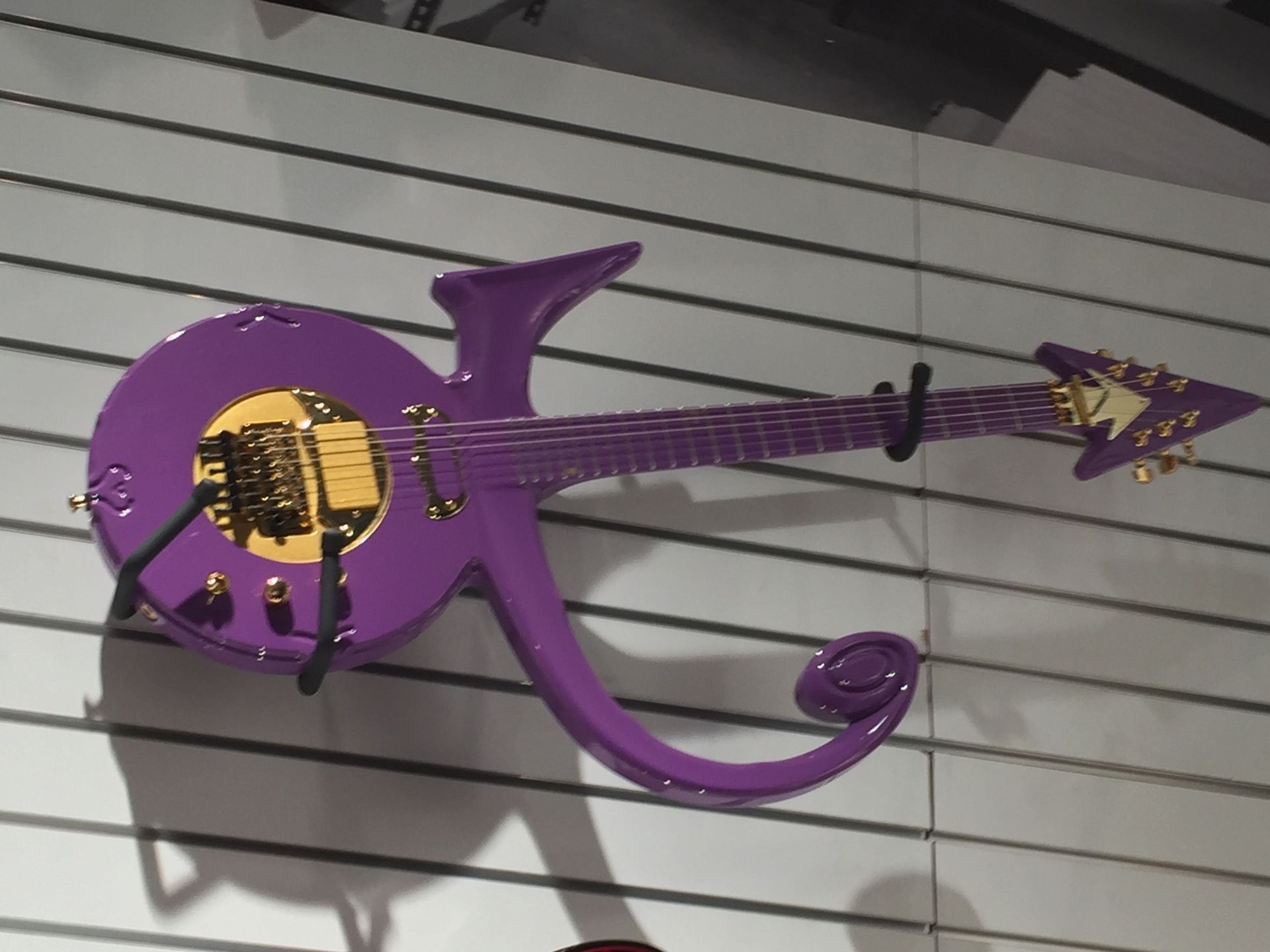 A purple guitar with the letter k on it