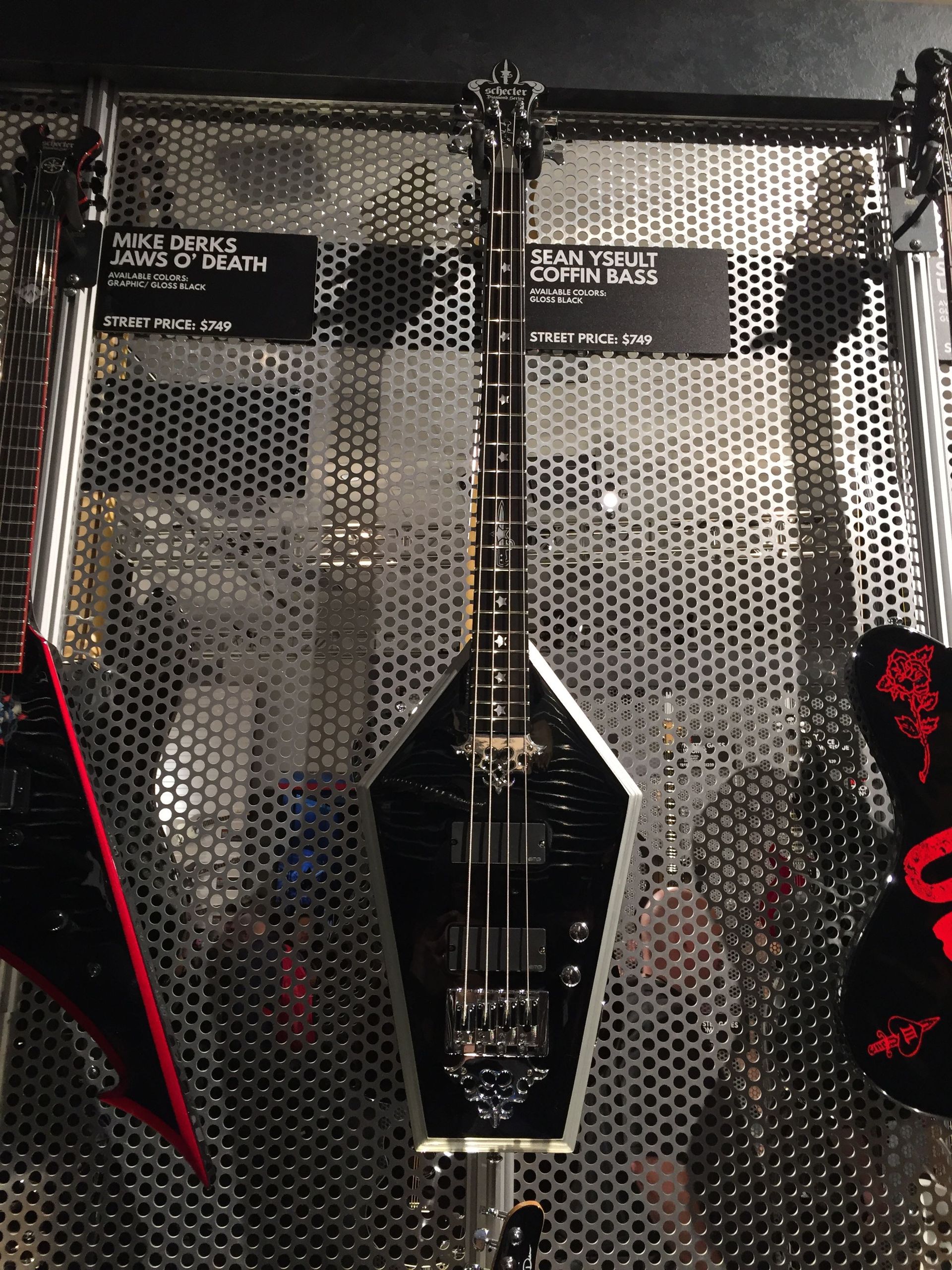 A guitar that looks like a coffin is on display