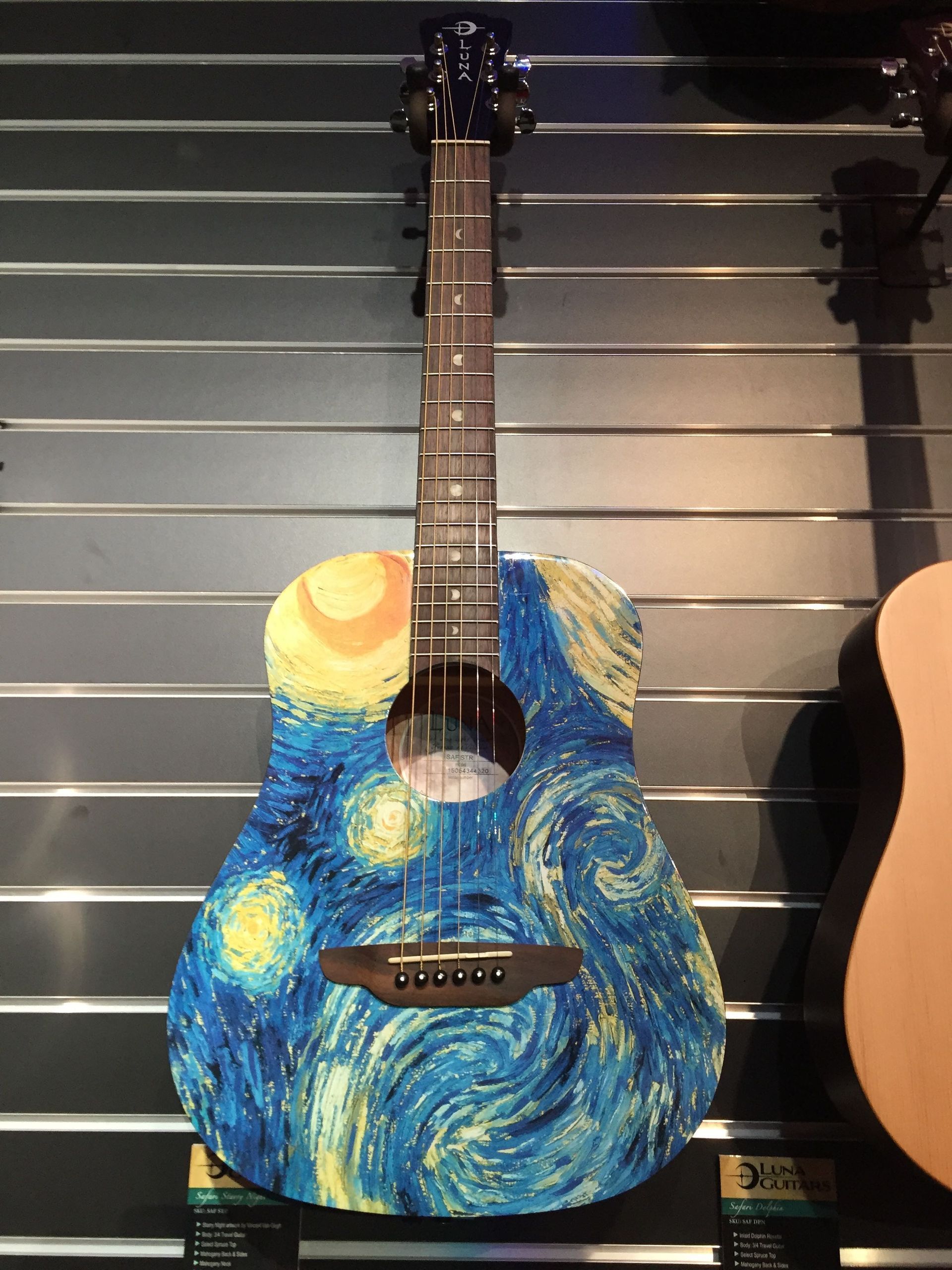 A guitar with a starry night painted on it