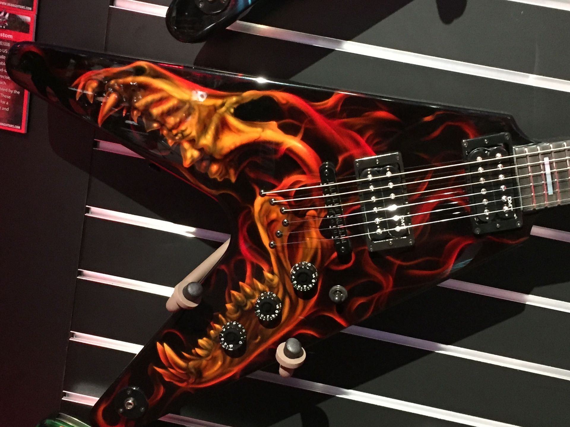 A guitar with flames and skulls painted on it
