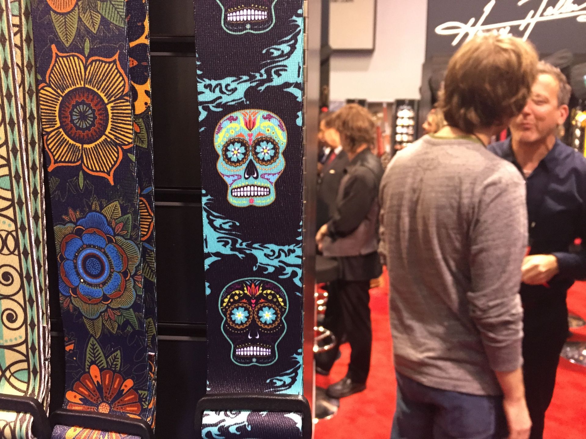 A group of people standing in front of a wall with skulls on it