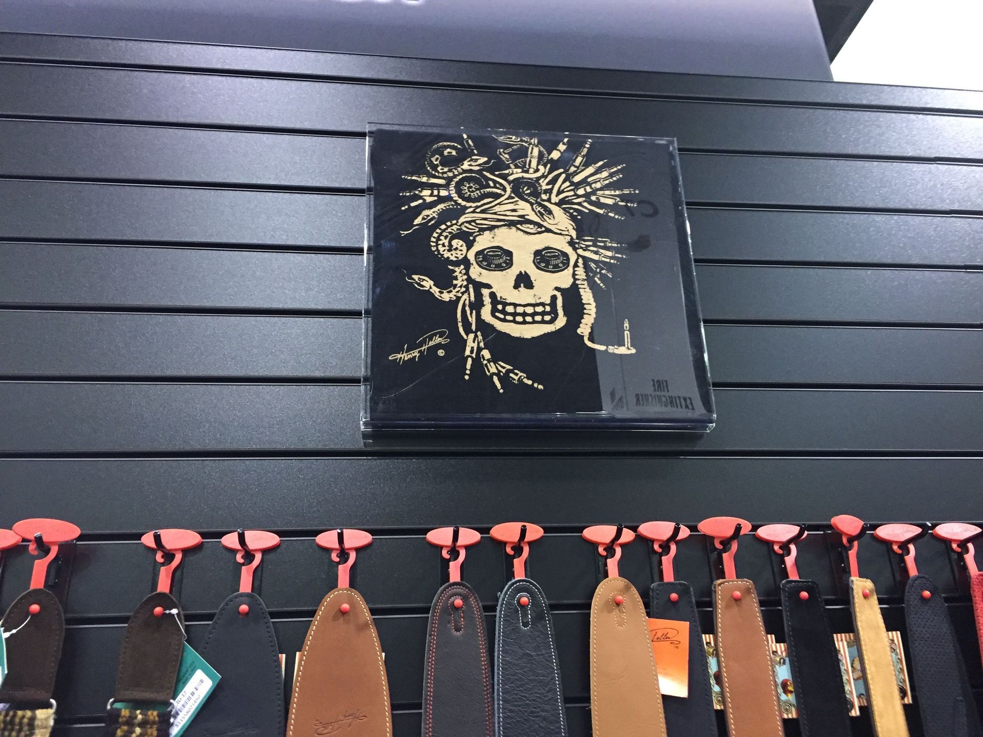 A black wall with a picture of a skull on it