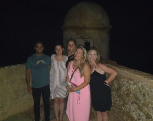 A group of people posing for a picture at night