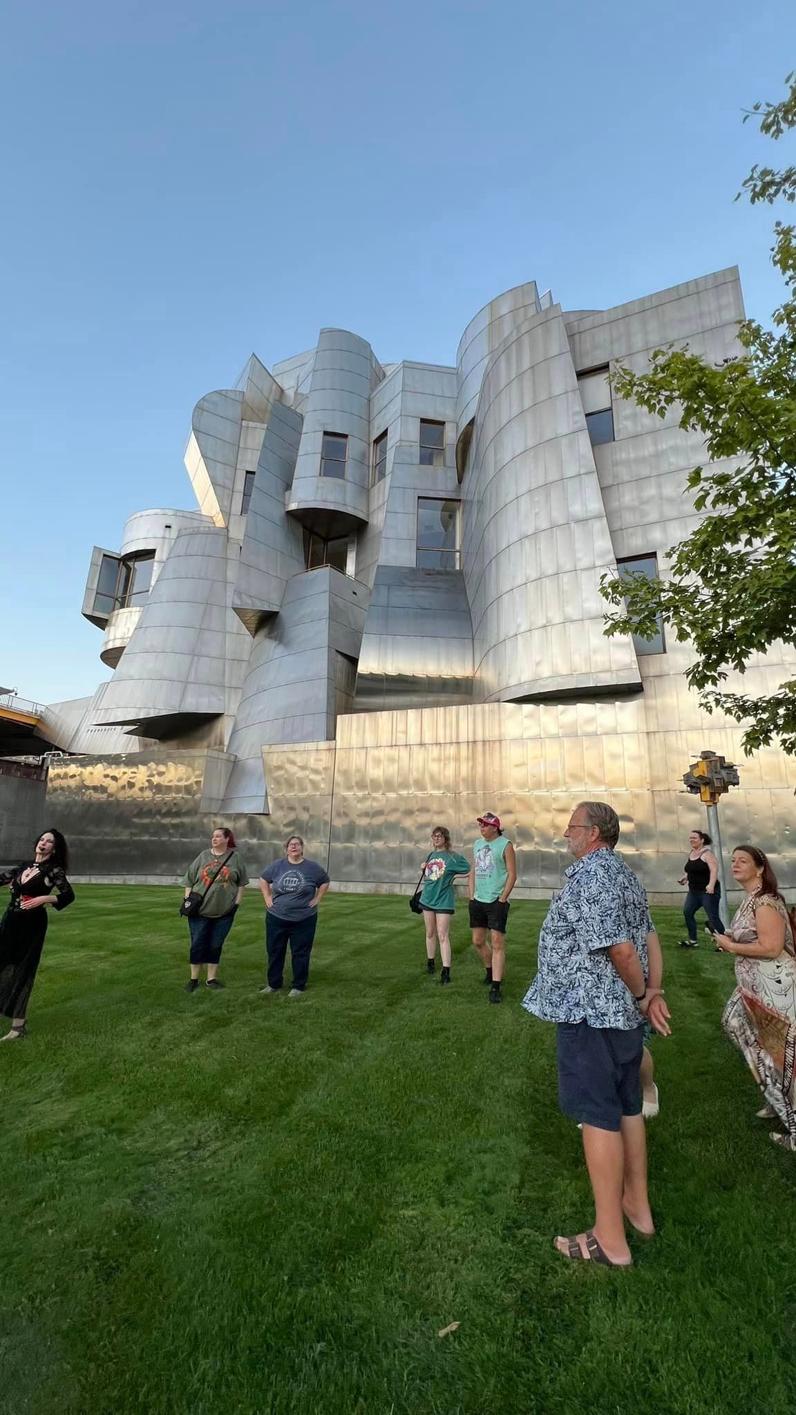 A group of people are standing outside the Walker Art Center